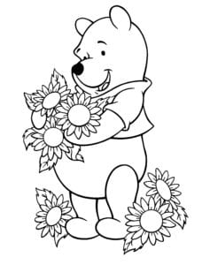 Desenho para colorir de Pooh cheirando girassois
